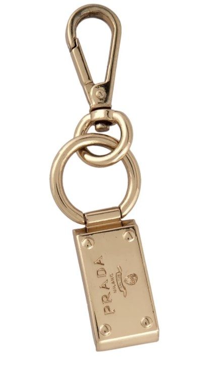 Authentic Prada Metal Logo keychain / bag charm (Category: Luxury Accessories) located in Rosario. Submitted by myvinatgepieces (Listing ID 1295996461, Image 1). Description: Authentic Gold metal Prada logo keychain / bag charm with lobster clasp closure Gold Hardware With signs of use Moderate scratches throughout..