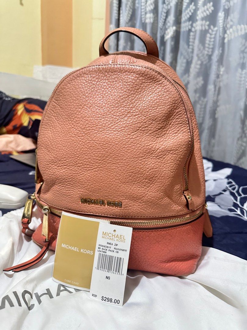 Original Michael Kors Rhea Zip (Category: Luxury Bags & Wallets) located in Trinidad. Submitted by _cherrymaed (Listing ID 1296010762, Image 1). Description: • Soft Venus Leather • 100% leather from tanneries meeting the highest standards of environmental performance from tanneries meeting the highest standards of environmental performance • Gold-Tone Hardware • 10"W X 11.75"H X 4.5"D • 2" Drop • 8"-9" Adjustable Strap • Interior: One Padded iPad