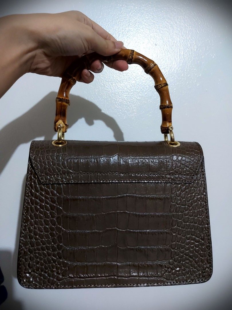 Italian signature authentic leather bag (Category: Purses & Pouches) located in Las Pinas. Submitted by s_abiera (Listing ID 1291360614, Image 2). Description: CLEARANCE SALE!! Color: Dark Beige 2 way bag, made from real italian leather (stamped animal skin) Made in Italy Bamboo handle and closure used only once, in very good condition..