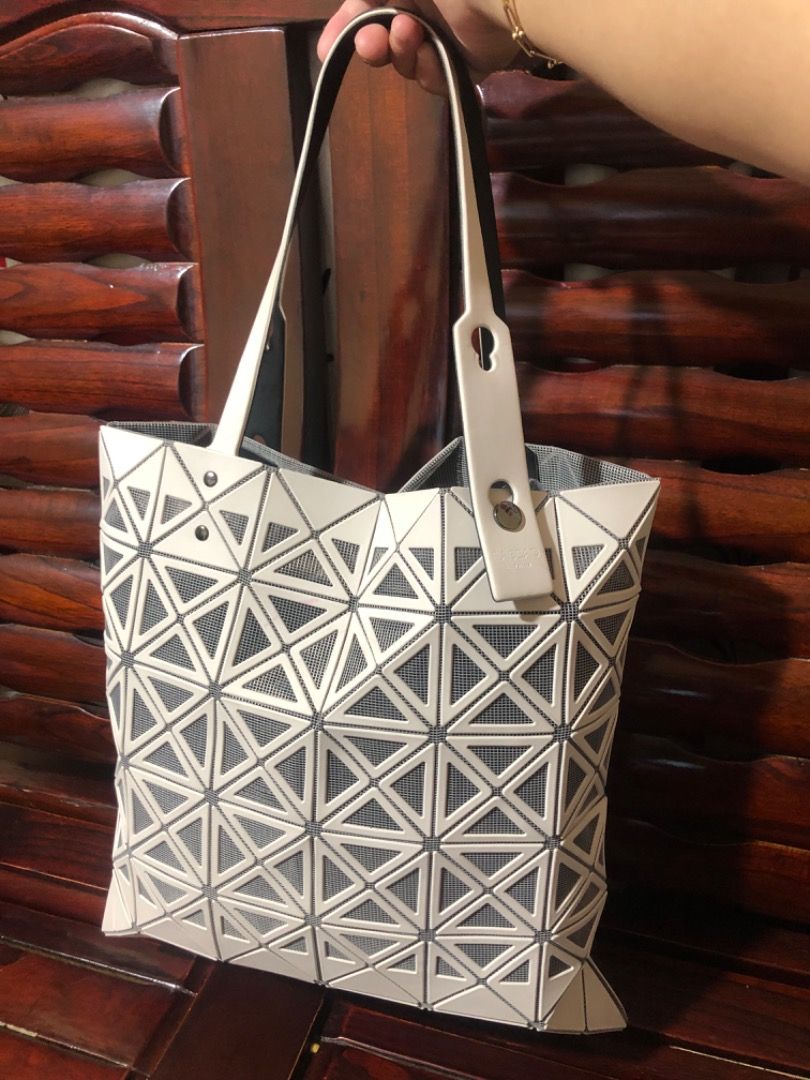 ISSEY MIYAKE PRISM TOTE (Category: Luxury Bags & Wallets) located in Lucena. Submitted by gracious_chin0436 (Listing ID 1291317713, Image 1). Description: Still in very good condition Normal to minimal sign of used only no major flaws/issue With some light color stain but unoticeable on strap and body Kindly check each pics for bag details and condition .