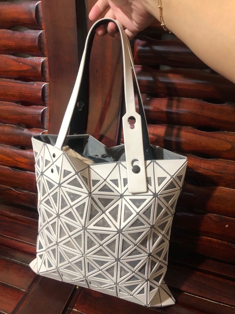 ISSEY MIYAKE PRISM TOTE (Category: Luxury Bags & Wallets) located in Lucena. Submitted by gracious_chin0436 (Listing ID 1291317713, Image 2). Description: Still in very good condition Normal to minimal sign of used only no major flaws/issue With some light color stain but unoticeable on strap and body Kindly check each pics for bag details and condition .