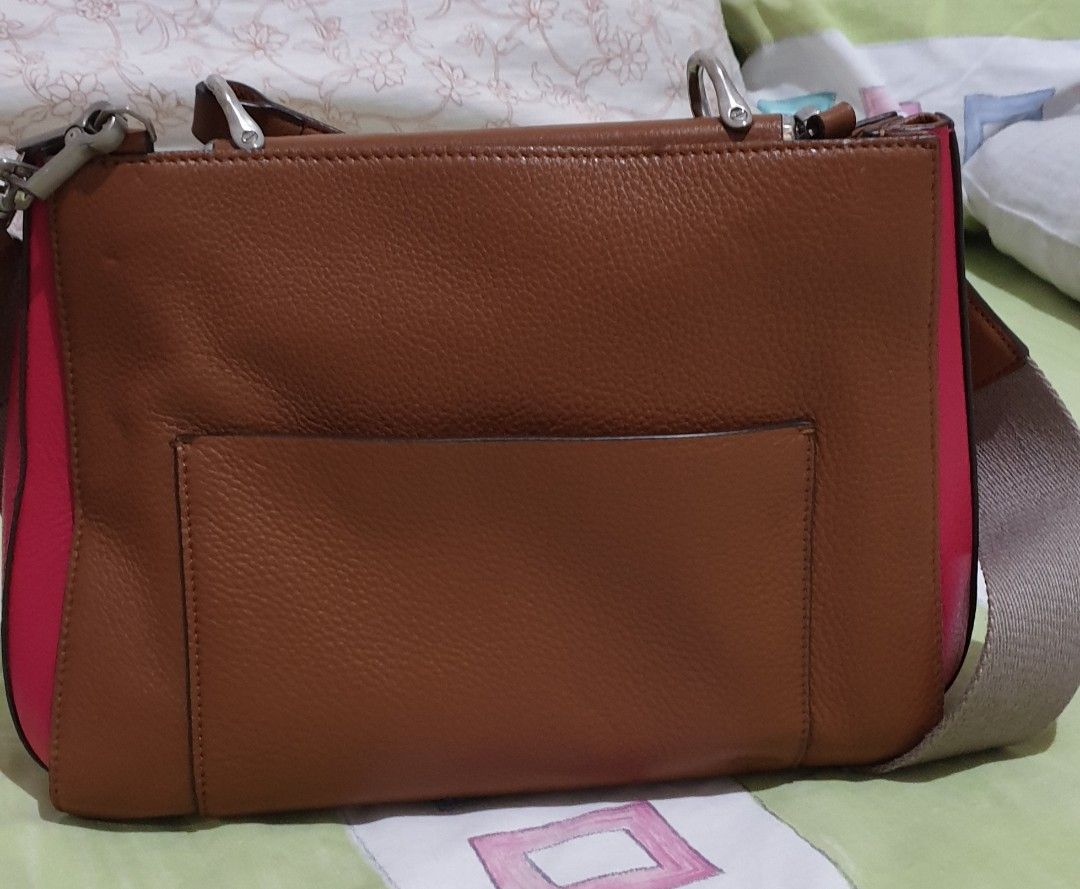 Louise Et Cie 2 Way Leather Bag (Category: Cross-body Bags) located in Manila. Submitted by graceperz (Listing ID 1291464069, Image 2). Description: From US Leather body, canvas polyester straps Double snap closures Color brown/pink combination Has minor flaws (please see picture) Can be used as handbag or crossbody bag Dust bag included.