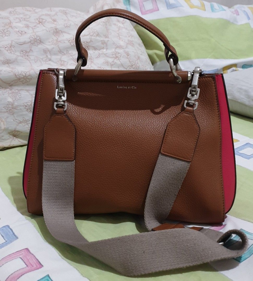 Louise Et Cie 2 Way Leather Bag (Category: Cross-body Bags) located in Manila. Submitted by graceperz (Listing ID 1291464069, Image 1). Description: From US Leather body, canvas polyester straps Double snap closures Color brown/pink combination Has minor flaws (please see picture) Can be used as handbag or crossbody bag Dust bag included.