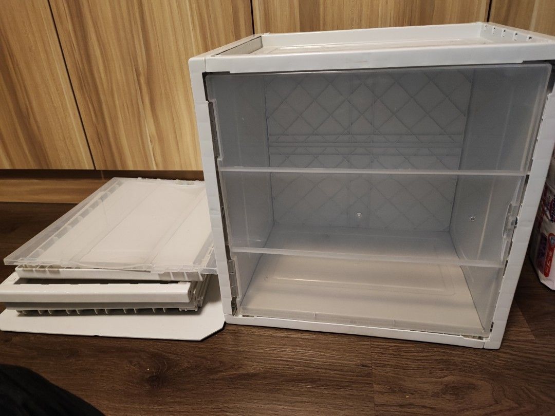 Stackable storage boxes (Category: Storage Boxes & Baskets) located in Singapore. Submitted by ynati (Listing ID 1291647302, Image 3). Description: 2 grey pieces. magnetic door. can dismantle easily when not in use. Retail one for $20. now one for $10, two for $16.