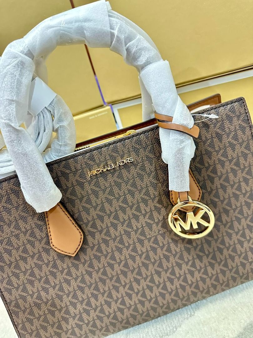 Michael Kors Sheila Medium Logo Satchel (Category: Luxury Bags & Wallets) located in Las Pinas. Submitted by chicchateaumnl (Listing ID 1291809492, Image 3). Description: 100% ORIGINAL BRAND NEW WITH TAGS , CARE CARDS & original packaging • Satchel • Logo-print canvas • 89.4% coated canvas/9.6% polyester • Trim: 60% polyurethane/20% cotton/20% polyester • Gold-tone hardware • 11”W X 8”H X 3.25”D • Handle drop: 4” • Exterior details: removable str