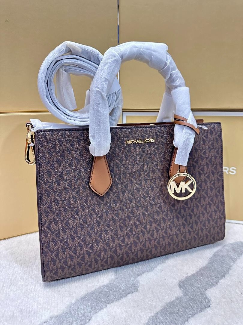 Michael Kors Sheila Medium Logo Satchel (Category: Luxury Bags & Wallets) located in Las Pinas. Submitted by chicchateaumnl (Listing ID 1291809492, Image 2). Description: 100% ORIGINAL BRAND NEW WITH TAGS , CARE CARDS & original packaging • Satchel • Logo-print canvas • 89.4% coated canvas/9.6% polyester • Trim: 60% polyurethane/20% cotton/20% polyester • Gold-tone hardware • 11”W X 8”H X 3.25”D • Handle drop: 4” • Exterior details: removable str