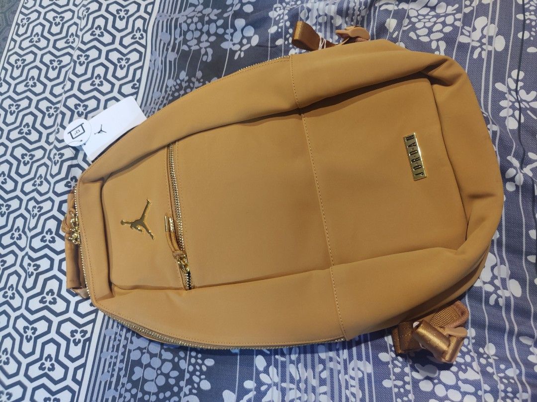 Nike Air Jordan Desert Ochre Backpack (Category: Backpacks) located in Pasig City. Submitted by ethpee (Listing ID 1291814868, Image 2). Description: Selling a BRAND NEW Nike Backpack freshly bought from the US!! ✅ Medium-sized Backpack that fits up to 13" laptops ✅ Suede Material Finish with Golden Zippers Price tag shows it retails for $85.00, roughly PHP 4700, but can let it go for PHP 4000!! Can send more pictures and do meet-ups around Pasig