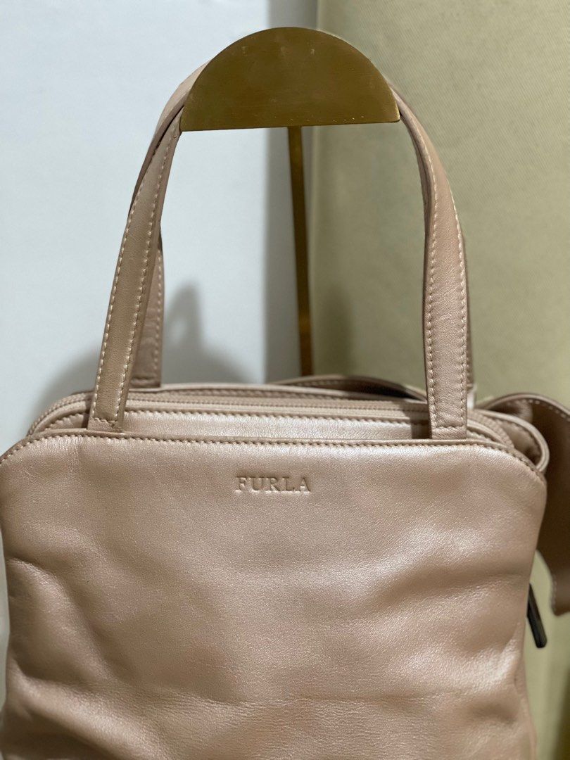 Furla Genuine Leather hand bag (Category: Luxury Bags & Wallets) located in Magalang. Submitted by stylerph (Listing ID 1291999803, Image 3). Description: Authentic Furla Genuine Leather Handbag with ribbon accent Minimal sign of use as shown in photos. Feel free to offer .