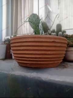 Orange clay ribbed wide plant pots with drainage holes for garden