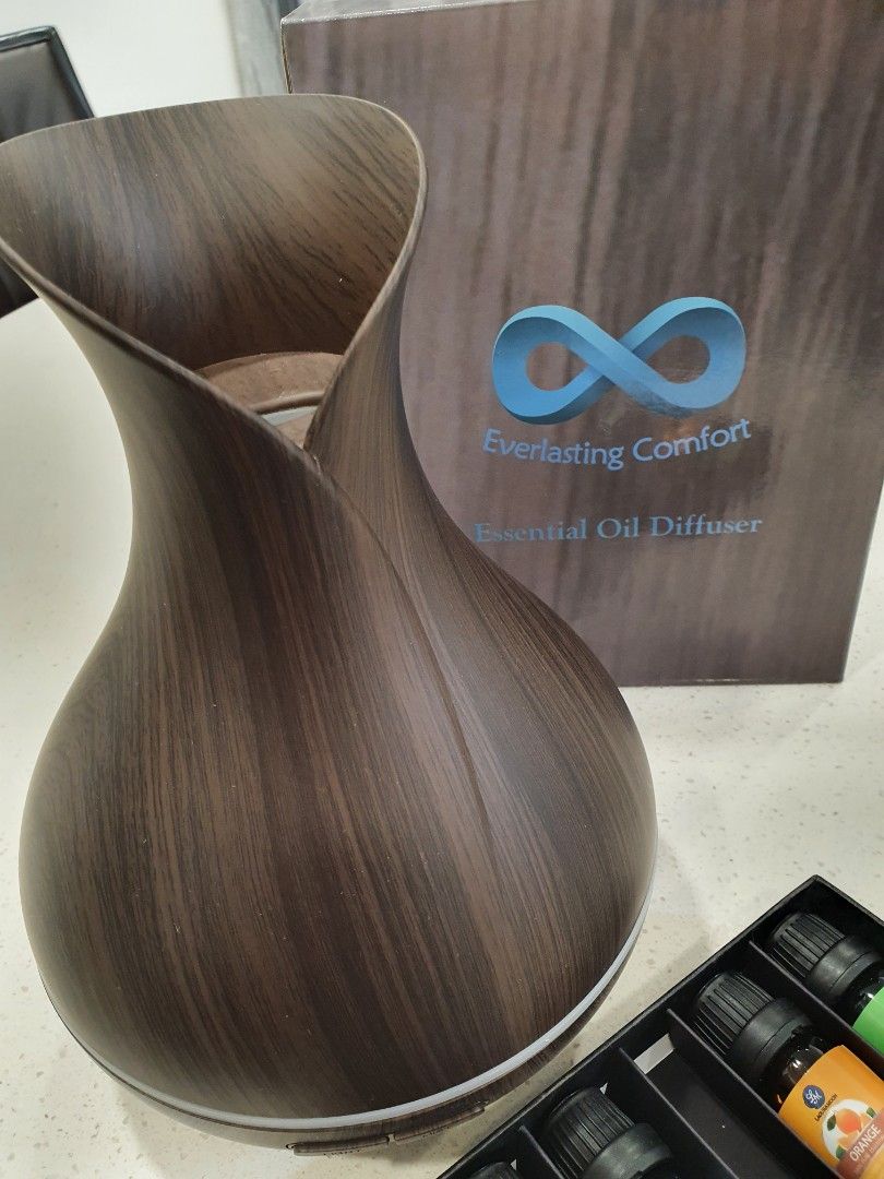 Essential Oil Diffuser (Category: Home Fragrance) located in Singapore. Submitted by mari0825 (Listing ID 1296107643, Image 1). Description: Essential Oil Diffuser. Lightly used, comes with essential oils (opened bottles, not all full).