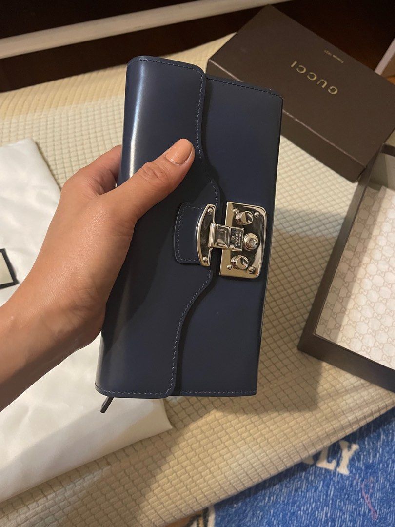 Gucci Authentic/ Orig (Category: Luxury Bags & Wallets) located in Calamba. Submitted by wakahatana (Listing ID 1296055070, Image 3). Description: Onhand Aug 2024. Dark blue leather with chain strap WOC, no sira/rubs/ lagkit/smell. Malinis. Dudumihan nalang. 😀 The silver chain is very shiny, can be your necklace. 12 card slots, many bill pocket. iPhone 14 and bigger phone fits. .