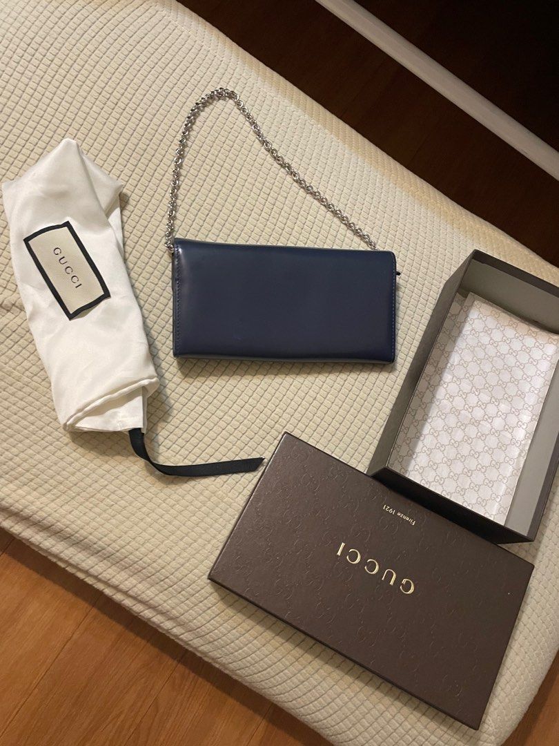 Gucci Authentic/ Orig (Category: Luxury Bags & Wallets) located in Calamba. Submitted by wakahatana (Listing ID 1296055070, Image 2). Description: Onhand Aug 2024. Dark blue leather with chain strap WOC, no sira/rubs/ lagkit/smell. Malinis. Dudumihan nalang. 😀 The silver chain is very shiny, can be your necklace. 12 card slots, many bill pocket. iPhone 14 and bigger phone fits. .
