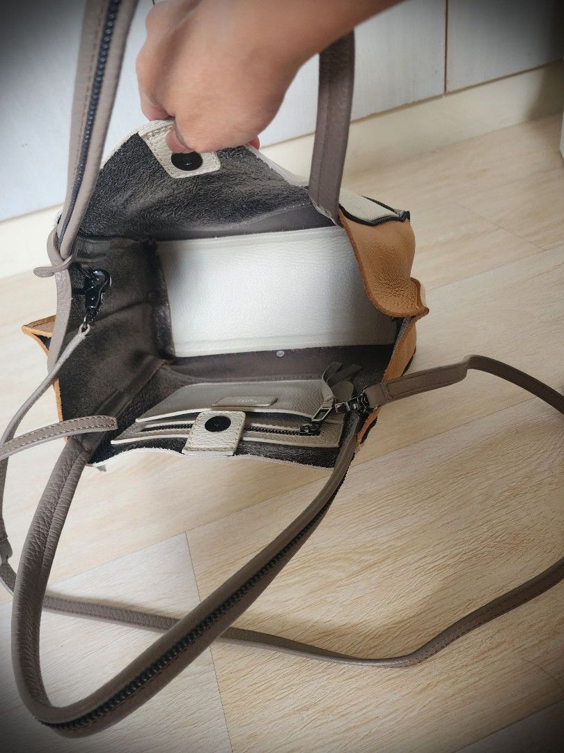 (SALE!) Botkier Leather Tote Bag (Category: Luxury Bags & Wallets) located in Quezon City. Submitted by queentana_finds (Listing ID 1297559956, Image 3). Description: Like new. No damage. Leather. The style and colors are unique and can easily match any clothing. Clean interior with 1 pocket with zipper inside. Comes with long handle so it can be worn as a body bad. Very functional, can fit a lot of stuff inside. From 6,500 to 5,900 to 4,900 unti
