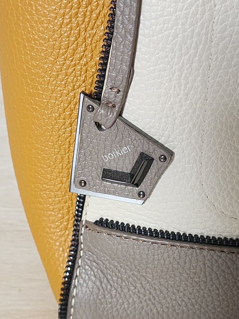 (SALE!) Botkier Leather Tote Bag (Category: Luxury Bags & Wallets) located in Quezon City. Submitted by queentana_finds (Listing ID 1297559956, Image 2). Description: Like new. No damage. Leather. The style and colors are unique and can easily match any clothing. Clean interior with 1 pocket with zipper inside. Comes with long handle so it can be worn as a body bad. Very functional, can fit a lot of stuff inside. From 6,500 to 5,900 to 4,900 unti