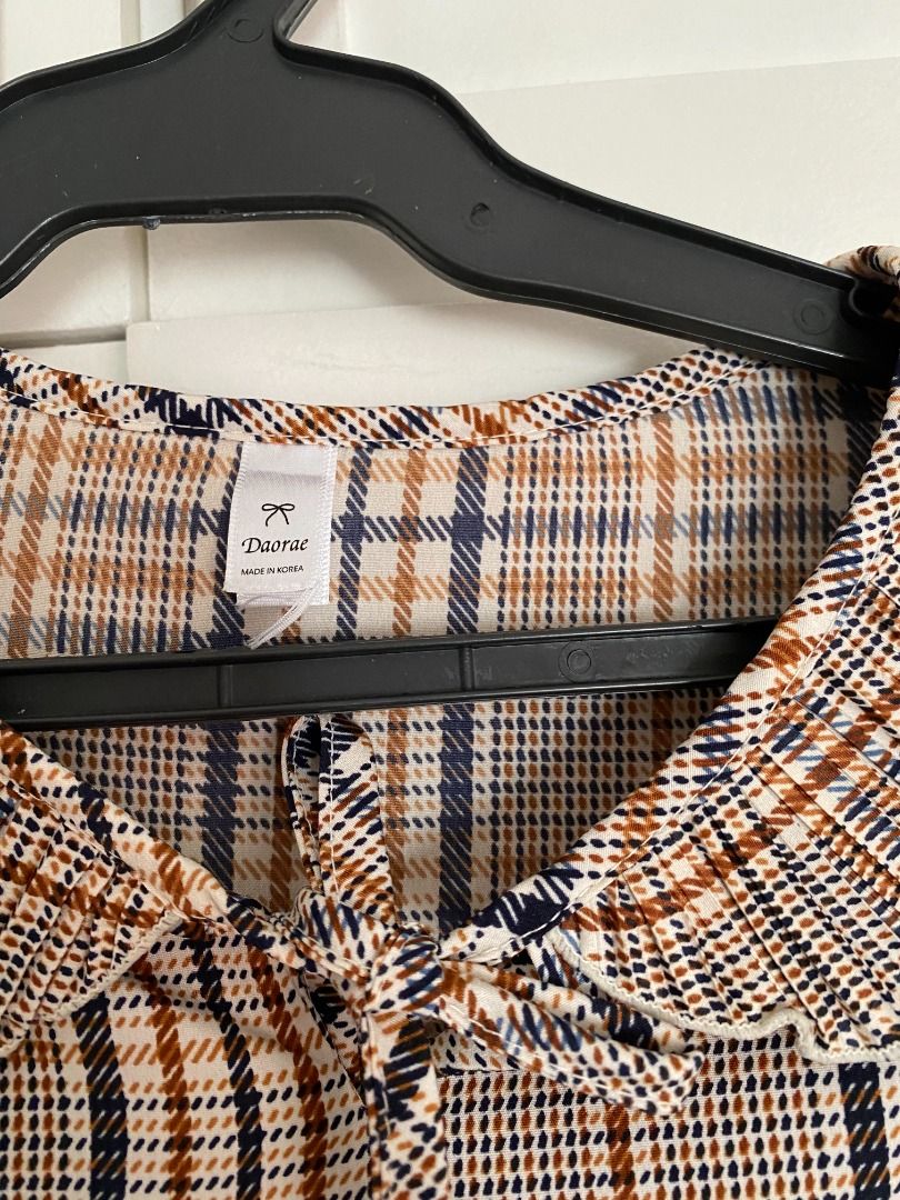 Daorae Plaid/Checkered Blouse (Category: Blouses) located in Quezon City. Submitted by briesells (Listing ID 1297744024, Image 2). Description: RFS: Decluttering. Need funds. Negotiable. Please message. Details: - Brand: Daorae - Size on tag: no size on tag but can fit up to size L - Color: shades of brown and black - No defects/issues. See my account bio for details on shipping and reservation (:.