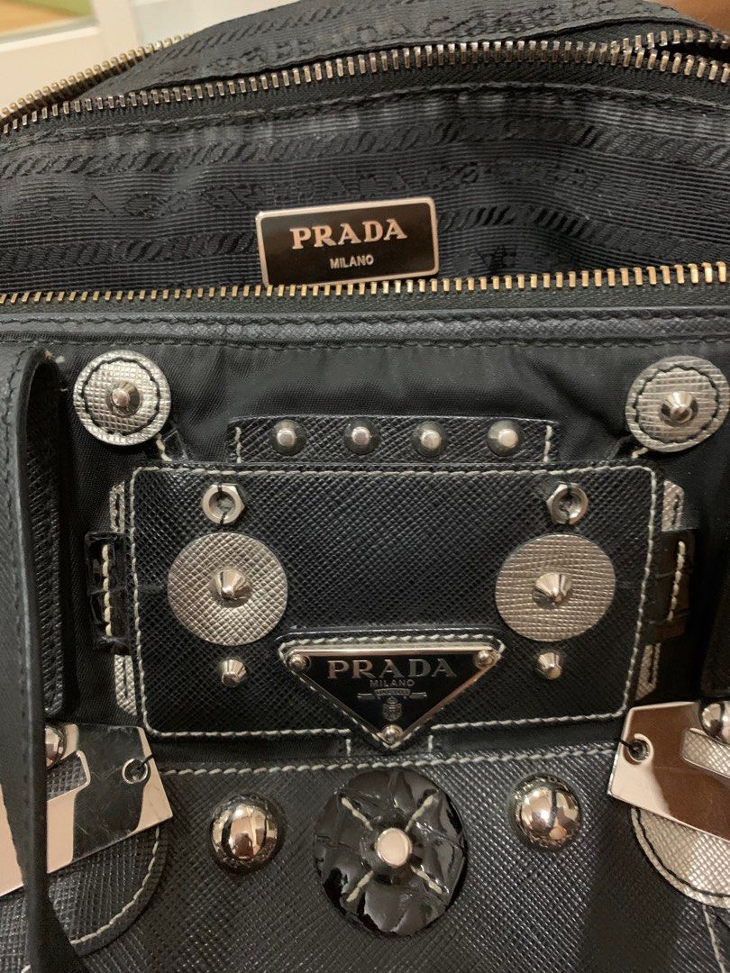Prada Robot Bag (Category: Luxury Bags & Wallets) located in San Fernando. Submitted by butterflymom16 (Listing ID 1297710333, Image 2). Description: Prada Tessuto Robot Bag Color Black With long strap Can be worn as hand bag and crossbody bag. Outer and Inner Zipper are intact Bought in Changi Airport Flaws: other parts removed as seen on the last photo. Complete: Paper Bag, Dustbag and cards .