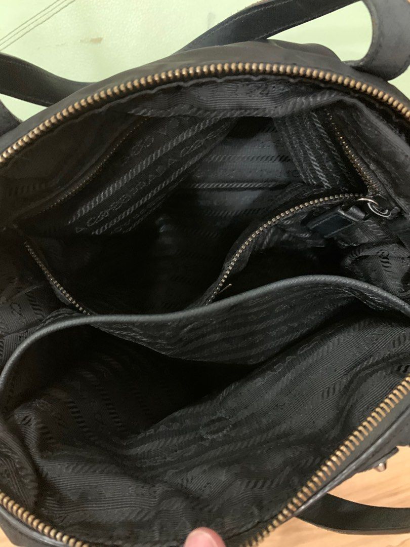 Prada Robot Bag (Category: Luxury Bags & Wallets) located in San Fernando. Submitted by butterflymom16 (Listing ID 1297710333, Image 3). Description: Prada Tessuto Robot Bag Color Black With long strap Can be worn as hand bag and crossbody bag. Outer and Inner Zipper are intact Bought in Changi Airport Flaws: other parts removed as seen on the last photo. Complete: Paper Bag, Dustbag and cards .