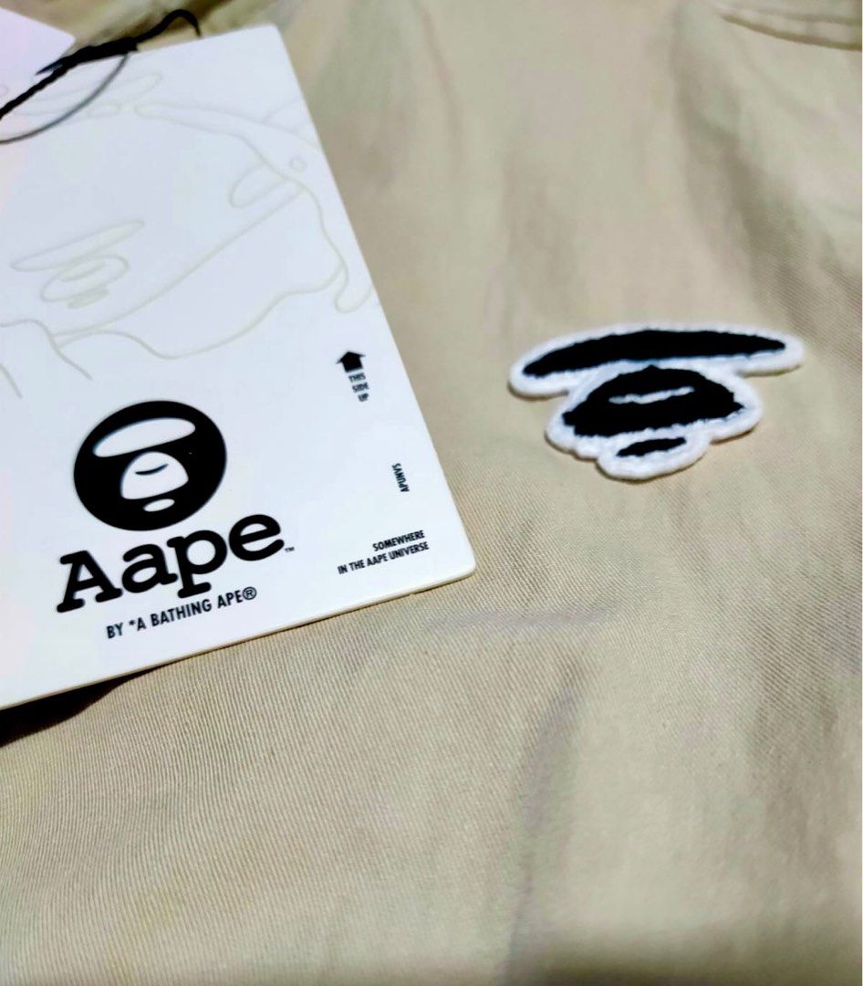 *SALE* Aape BY *A BATHING APE® Light Weight Drizzler Jacket Beige AAPLJM7643XXMBGE (Category: Coats, Jackets and Outerwear) located in Singapore. Submitted by nofrillsfactoryoutlet (Listing ID 1297883786, Image 8). Description: Usual : $388 SUPER HOT DEAL : $299 100% Authentic and Brand New with Tags and packaging. Direct from Aape BY *A BATHING APE® outlet in Beijing. Brand : Aape BY *A BATHING APE® Design : Moon Face Embroidered Drizzler Jacket