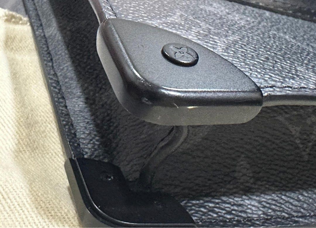 LV Trunk Pouch Monogram Eclipse (Category: Bags & Wallets) located in Singapore. Submitted by liongate108 (Listing ID 1297975964, Image 3). Description: As good as new just a minor scratch at the bottom (3rd photo attached) .