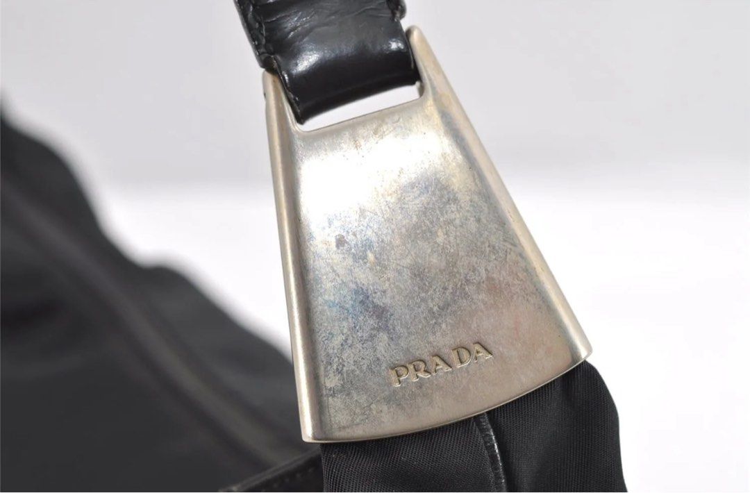 Preloved PRADA Nylon Tessuto Leather Shoulder HandBag (Category: Luxury Bags & Wallets) located in Makati City. Submitted by luxebyjoyce (Listing ID 1298256007, Image 3). Description: Authentic 💯 No inclusions Nylon material Issues: Signs of usage. Color: Black with silver hardware Rank B Location: Makati MOP: BPI and Gcash .