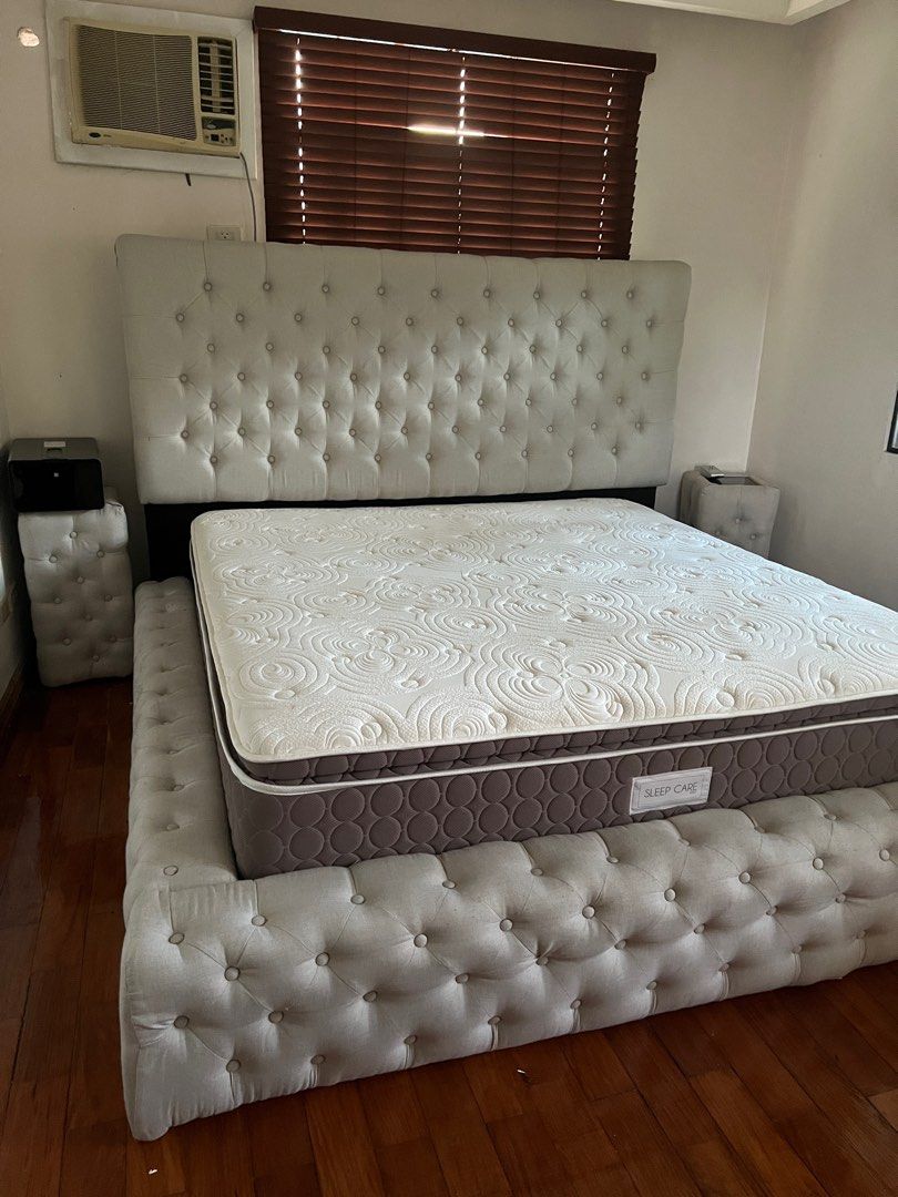 Beige King Sized Bed Frame with Side Tables (Category: Bed Frames & Mattresses) located in Taguig. Submitted by girlbossatwork (Listing ID 1298449537, Image 2). Description: KING-SIZED BEDFRAME. Just needs cleaning. Mattress not included in the price. Combining comfort, style, and durability, this bed frame is a perfect centerpiece for any master bedroom. High Back Frame: The tall, upholstered headboard adds a touch of grandeur and provides excel