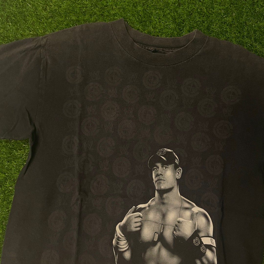 WWE John Cena Solo Shirt (Category: Community) located in Quezon City. Submitted by emporium.vtg (Listing ID 1298366812, Image 1). Description: World Wrestling Entertainment John Cena Solo Mega Print Black Shirt Cut Tag / Single Stitch Neck Size Medium Dimensions: 19.5”x27” Issue: minor loose stitch on neck & good fade.