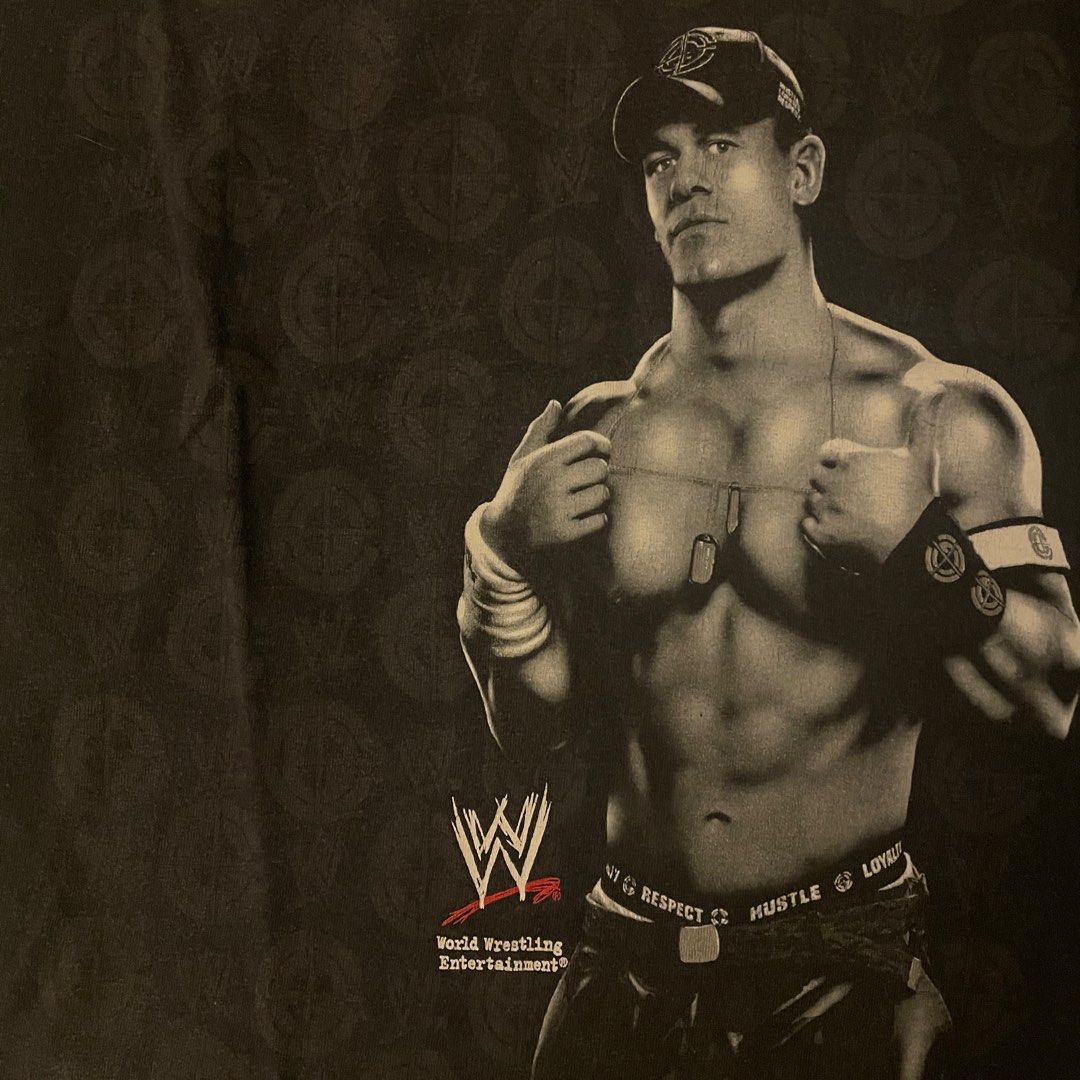 WWE John Cena Solo Shirt (Category: Community) located in Quezon City. Submitted by emporium.vtg (Listing ID 1298366812, Image 3). Description: World Wrestling Entertainment John Cena Solo Mega Print Black Shirt Cut Tag / Single Stitch Neck Size Medium Dimensions: 19.5”x27” Issue: minor loose stitch on neck & good fade.
