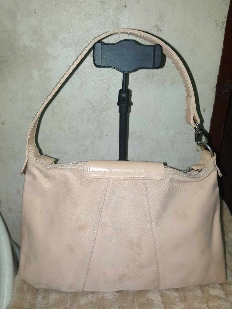 Longchamp handbag (Category: Luxury Bags & Wallets) located in Quezon City. Submitted by neverfoundland (Listing ID 1298610439, Image 2). Description: Longchamp handbag used with stain issues (see photos) beige Made from canvas and leather Manufacturer size: Small Closing type: zipper CUT : 30 a 34 cm Dimensions: H:20 x L:30 x P:6.5 cm Min / max shoulder strap length (cm) : 40.