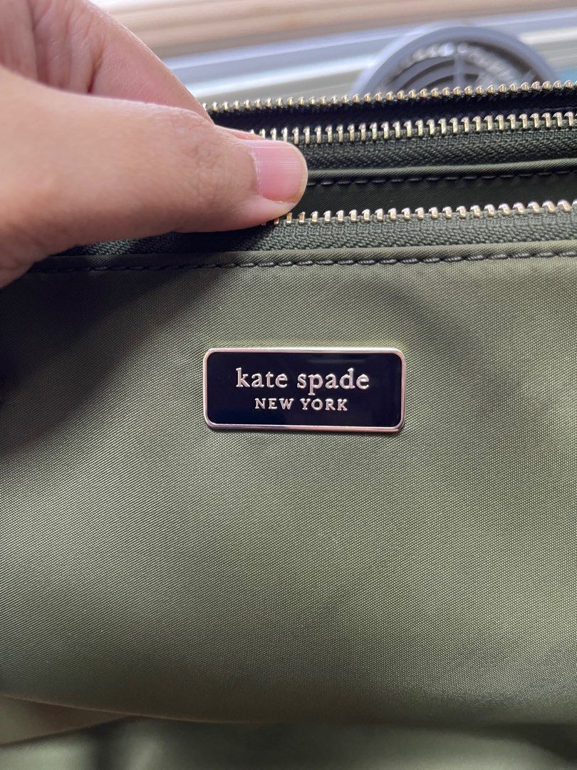 Original Kate Spade Satchel (Category: Tote Bags) located in Quezon City. Submitted by xtn18 (Listing ID 1298508313, Image 2). Description: Original Kate Spade Satchel Square size with adjustable straps Slightly used. In very good condition. Only flaw is the lining of straps as seen on photos. Material: nylon Color: army green.