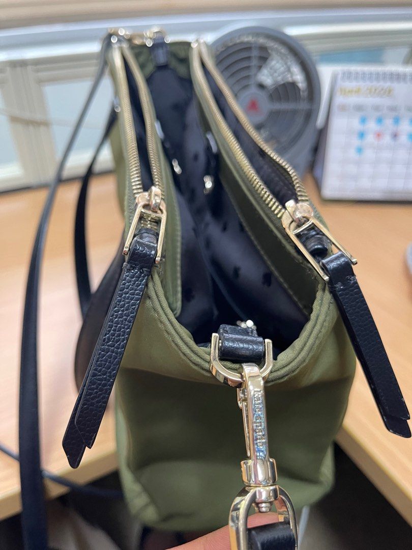Original Kate Spade Satchel (Category: Tote Bags) located in Quezon City. Submitted by xtn18 (Listing ID 1298508313, Image 3). Description: Original Kate Spade Satchel Square size with adjustable straps Slightly used. In very good condition. Only flaw is the lining of straps as seen on photos. Material: nylon Color: army green.