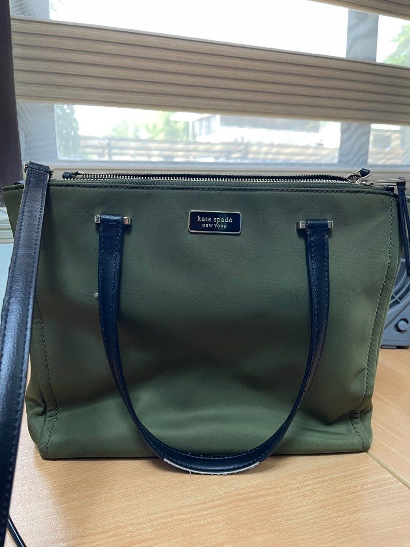 Original Kate Spade Satchel (Category: Tote Bags) located in Quezon City. Submitted by xtn18 (Listing ID 1298508313, Image 1). Description: Original Kate Spade Satchel Square size with adjustable straps Slightly used. In very good condition. Only flaw is the lining of straps as seen on photos. Material: nylon Color: army green.