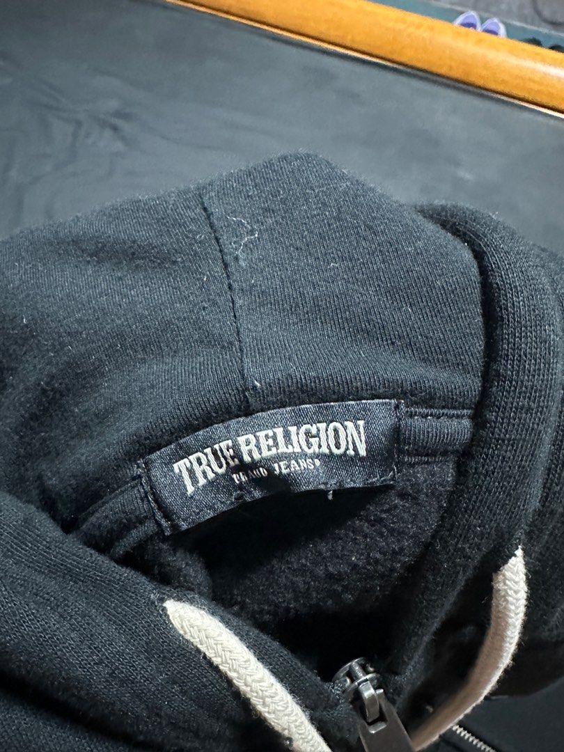 TRUE RELIGION ZIP-UP HOODIE (Category: Coats, Jackets and Outerwear) located in Iloilo. Submitted by calvingrrvillo (Listing ID 1298531586, Image 1). Description: Color Black Size M 21x27 dimes Very good condition Not thrifted.