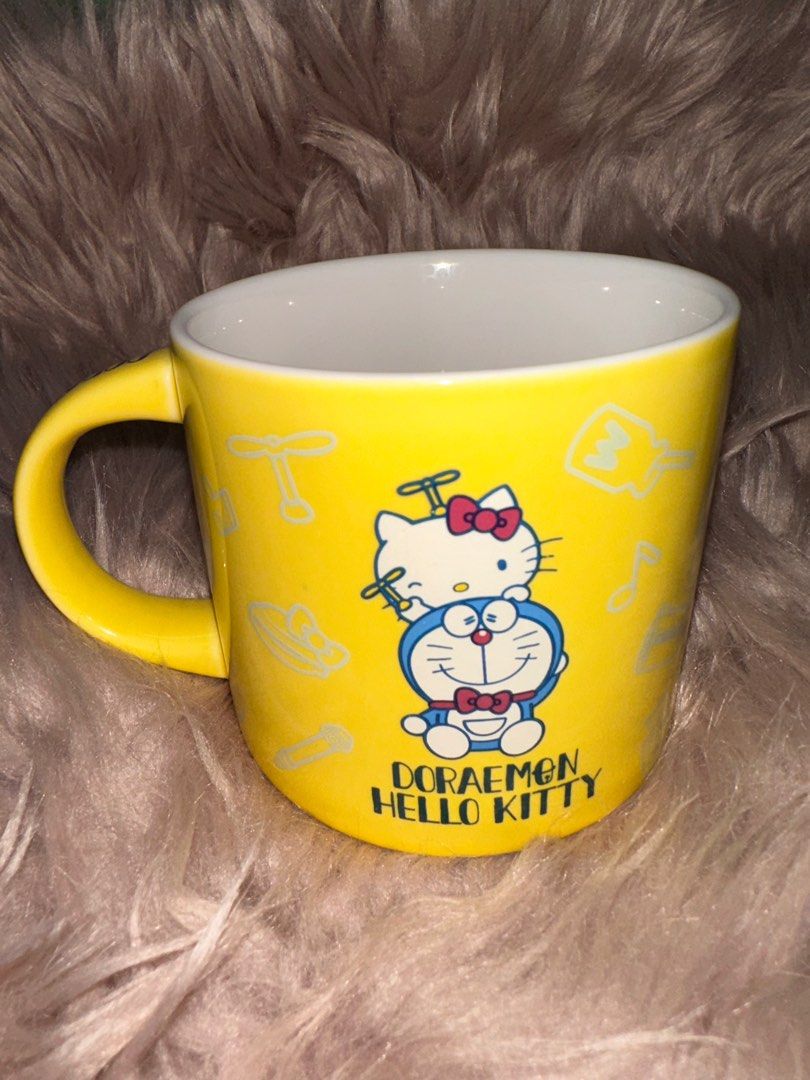 Sanrio Doraemon x Hello Kitty Mug (Category: Coffee & Tea Tableware) located in Manila. Submitted by rarefindsgallery (Listing ID 1298775168, Image 1). Description: Sanrio Doraemon x Hello Kitty Mug Height: 3.5” Diameter: 3.25” Material: Porcelain k Made in Japan 🇯🇵 Authentic Sanrio Good as new.