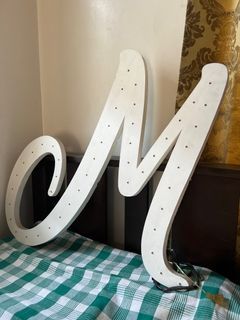 White letter M Standee with fairy lights