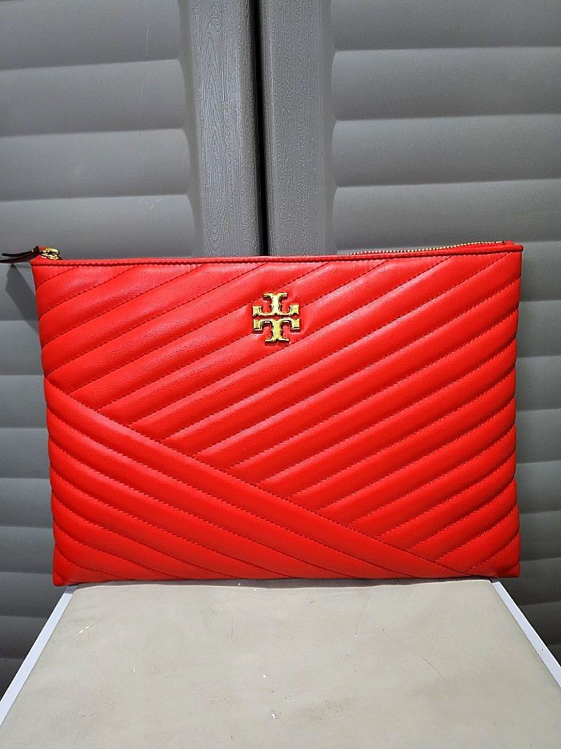 Tory Burch Kira Chevron Quilted Clutch (Category: Clutches) located in Pasay City. Submitted by dylan.fs (Listing ID 1297677293, Image 2). Description: BNWOT: Tory Burch Kira Chevron Quilted Pouch/Clutch. No flaws. Please check and zoom in on the photos for better appreciation. Measures approximately: W = 13.5 inches L = 9.5 inches Please take note of the following before making an offer: • Make sure that you are 100% certain in buying the item. 