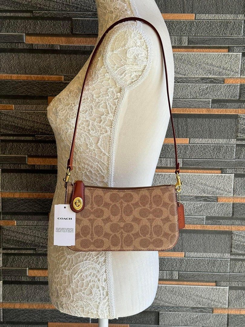 Coach penne shoulder bag (Category: Luxury Bags & Wallets) located in Mandaluyong City. Submitted by stuffnmore (Listing ID 1296366384, Image 2). Description: RETAIL ITEM Coach PENN shoulder bag Pinas onhand Inclusion tag dustbag polybag and carecard Guaranteed original and new Product Details Signature coated canvas and refined calf leather Three credit card slots Zip-top closure, leather lining Detachable strap with 30.5cm drop 21cm (L) x 12cm 
