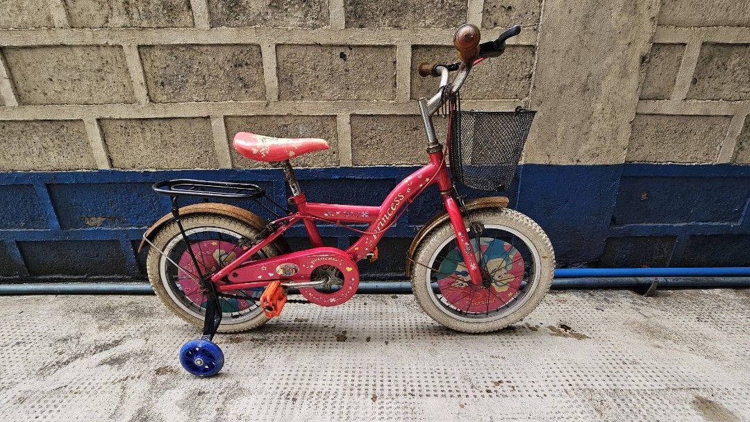 Kid's Disney Princess Bike (Category: Bicycles) located in Quezon City. Submitted by kardinalfire (Listing ID 1299323322, Image 1). Description: Kid's Disney Princess Bike - Well Used - Training wheels included - Some parts have rust but will brush off - Chain is intact - Wheels would need to be replaced - Sold as is #bike #disneyprincess #kidsbike.
