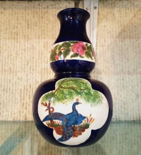 Hand painted peacock on vase