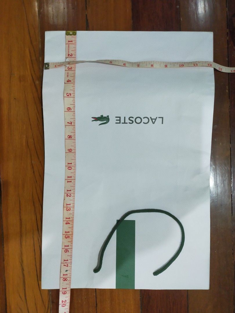 Lacoste paper bag Large (Category: Luxury Accessories) located in Valenzuela. Submitted by cletini (Listing ID 1299478982, Image 2). Description: Swipe pic for size. Could fit bulky jackets. Flaw: swipe 3rd pic slight dirt. "Might" be removed with erasure. .