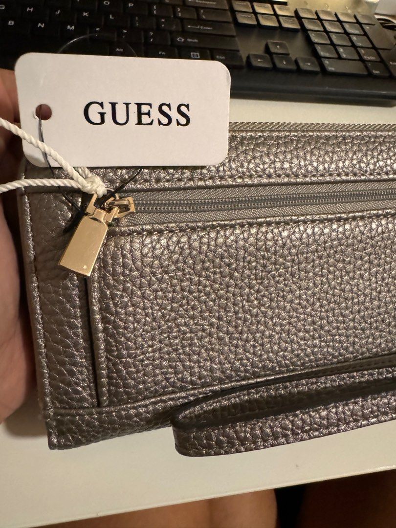 Original Guess Long Wallet - Silver with Gold Hardware (Category: Wallets & Card holders) located in Las Pinas. Submitted by melc1895 (Listing ID 1299542885, Image 3). Description: Price Negotiable Brand New Original Guess Eco ♻️ With 12 Card Slots With external and internal zipper/pockets Silver color with gold hardware.
