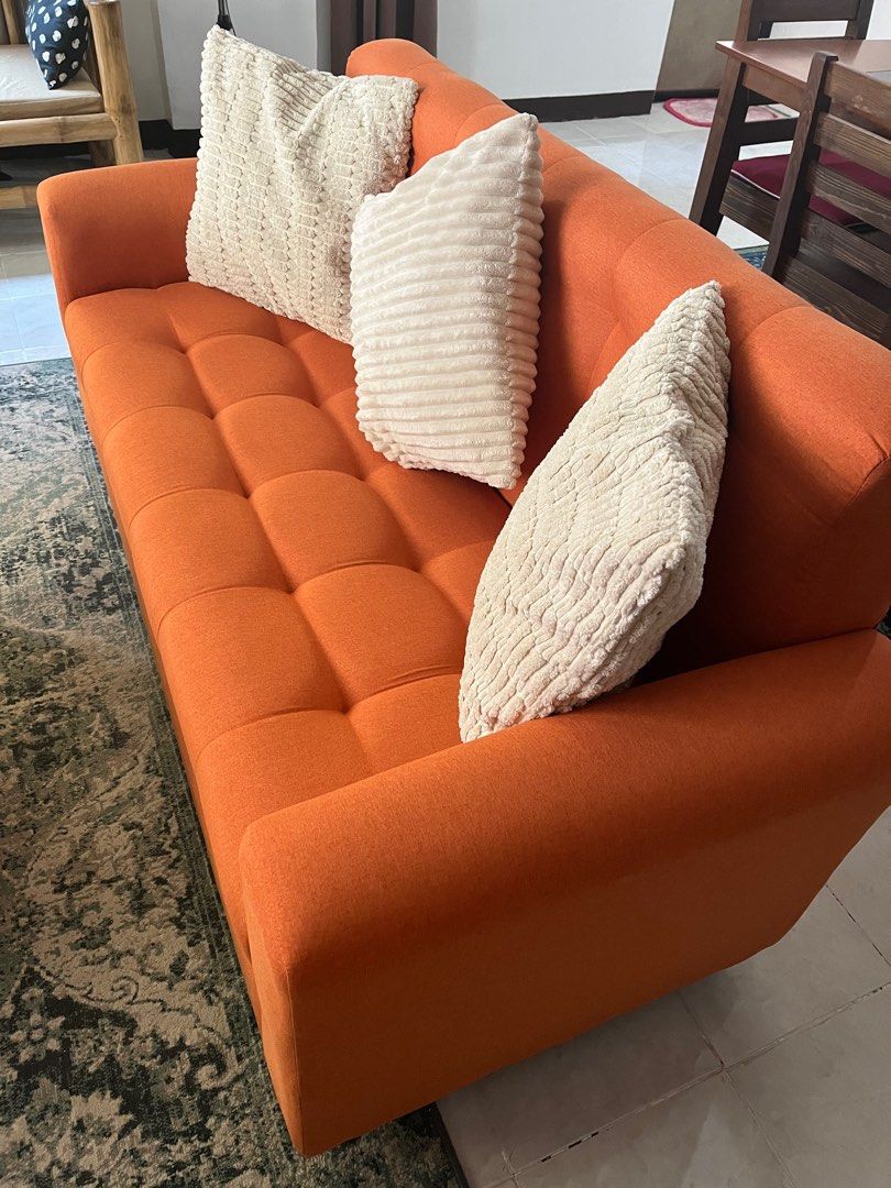 Orange Three Seater Sofa With Dimples (Category: Sofas) located in Las Pinas. Submitted by abby_e_g (Listing ID 1299628415, Image 2). Description: Uratex Foam Italian Fabric Solid Wooden Frame that will last Easy to maintain L60 inches W26 inches H32 inches Ship via lalamove only or pick up Gcash/BPI Payment Made to order for other colours.