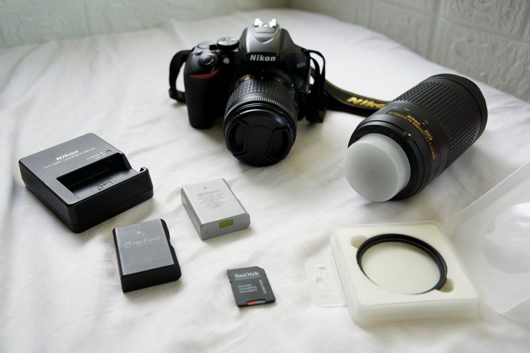 Nikon D3500 Package🔥 (Category: Cameras) located in Quezon City. Submitted by jadeandjacob (Listing ID 1300057544, Image 2). Description: Nikon D3500 Package🔥 💰Price: ₱39888 * Nikon D3500 body with strap * 2 included lens: ->Kit lens (18-55mm) ->Telephoto lens (70-300mm) * CADeN Camera Bag (large storage space) * Nikon battery charger * 2 Nikon rechargeable batteries * 64 GB SD Card * K&F Concept Nano-C Series Black Diffusion Mist Filter (1/8)