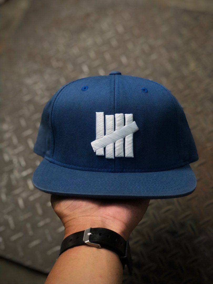 Topi Undefeated Logo Blockhead Script Blue Snapback Hat, Fesyen