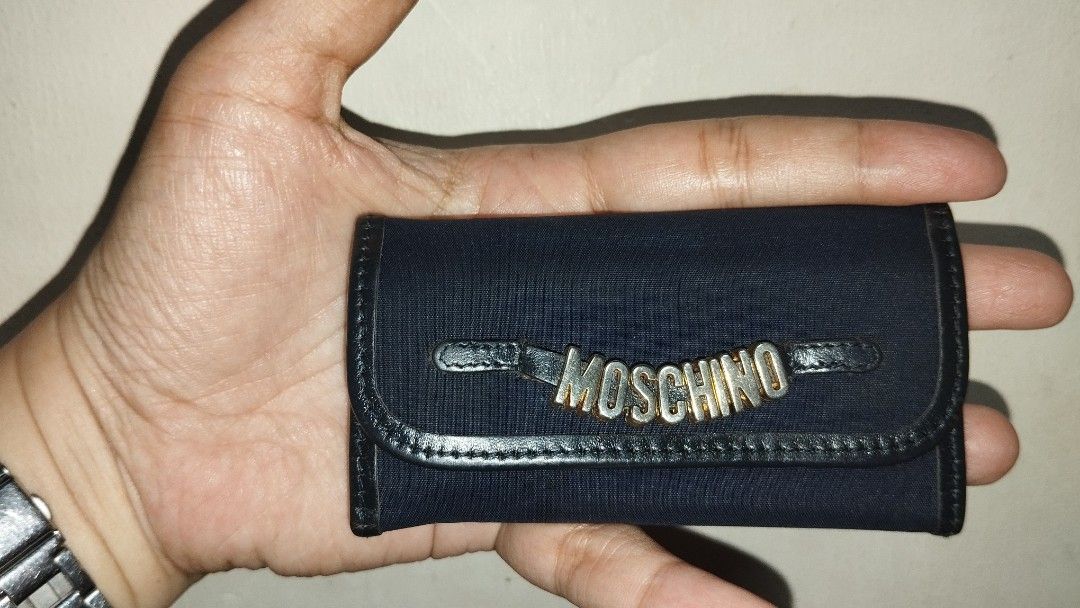 Vintage Moschino Redwall 6 Ring Key Holder (Category: Luxury Bags & Wallets) located in Taguig. Submitted by bellecabano (Listing ID 1300066293, Image 3). Description: Vintage Moschino Redwall 6 Ring Key Holder Made in Italy, coded and searchable combination of thick nylon and genuine leather no rips and tears and no runs selling low, hindi na gold si moschino sa front ready to use, cleansed and conditioned *** very compact, kasya kahit SA maliit