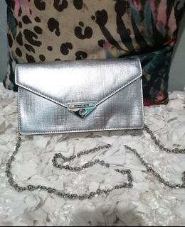 MK silver envelope sling bag