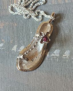 Vintage sterling silver slippers with garnet stone accent pendant.