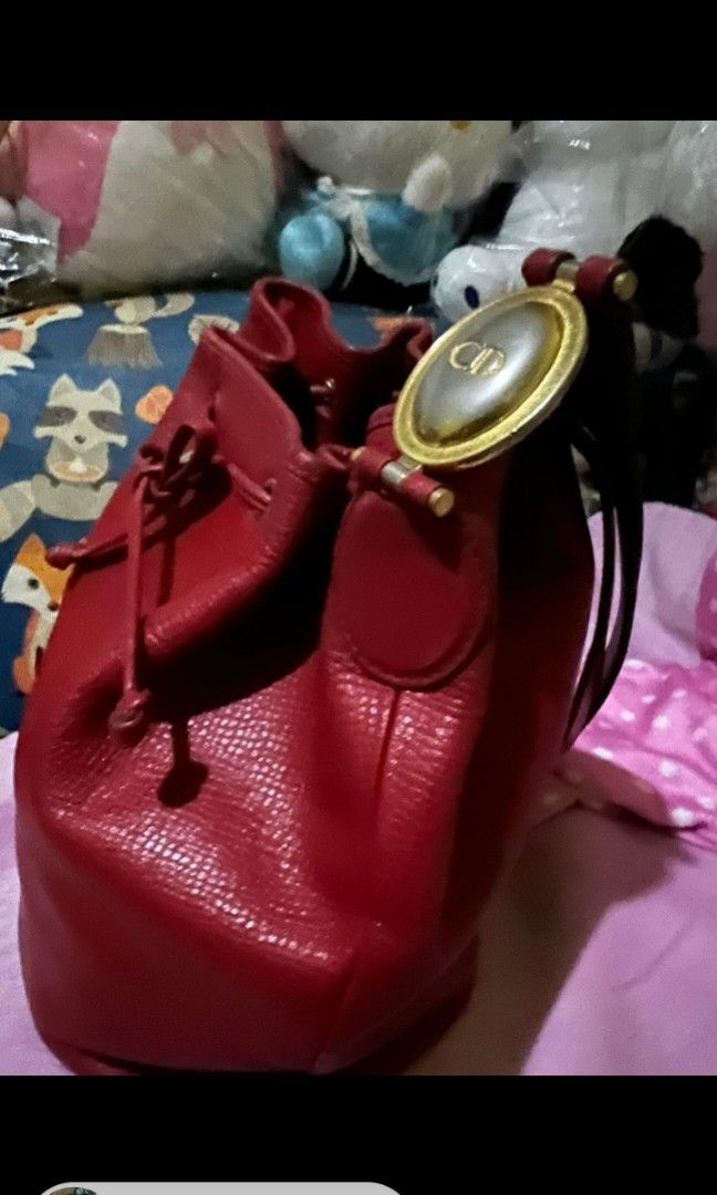Christian Dior Small Bucket bag (Category: Luxury Bags & Wallets) located in Quezon City. Submitted by uptrendglam (Listing ID 1300661324, Image 2). Description: Christian Dior small bucket bag with engraved back to back CD and Christian Dior on the bag's metal design. Issue: Minor rubs on the interior side of the bag near zippered pocket and dirt on the inner side of the said pocket. Guaranteed authentic. RFS : Decluttering.