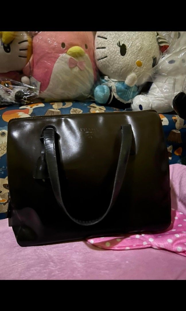 PRADA shoulder bag with lock and key (Category: Luxury Bags & Wallets) located in Quezon City. Submitted by uptrendglam (Listing ID 1300654452, Image 1). Description: Prada Brown patent leather bag with lock and key. Minor signs of usage. Guaranteed authentic. RFS: Decluttering.