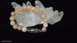 Yellow jade bracelet with DZI stone