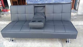 Black leather sofabed with cup holder